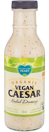 photo of organic vegan caesar salad dressing by follow your heart brand packaged in a glass bottle and black screw on plastic cap and green and cream pper label