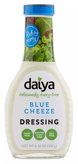 photo of vegan blue cheese salad dressing by daiya brand packaged in glass bottle with screw on plastic cap and a white paper label